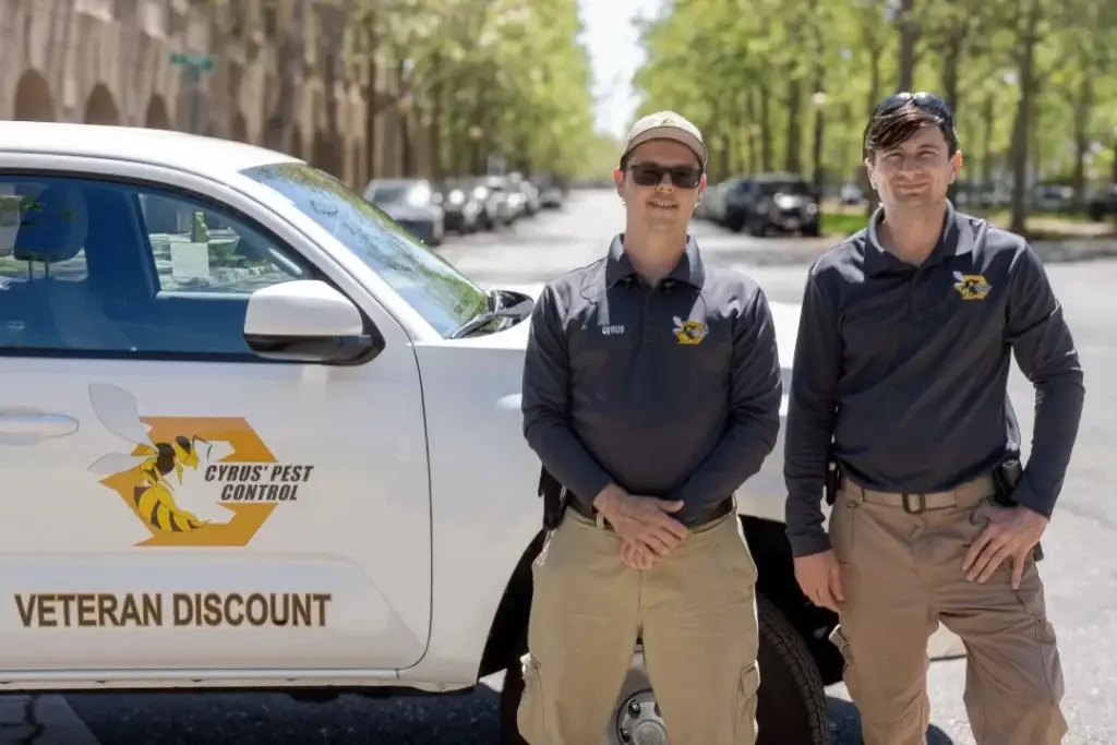 Cyrus and Brad standing in front of work truck